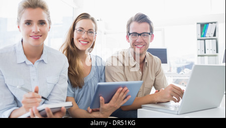 Portrait of three young people in office Stock Photo
