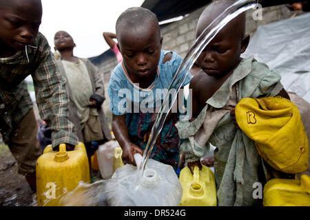 Dec 02, 2008 - Goma, Democratic Republic of Congo - Congolese children jostle while trying to fill containers with drinking water at the IDPs (internally displaced person) camp at the Don Bosco center in Ngangi, north of Goma. (Credit Image: © T.J. Kirkpatrick/ZUMA Press) Stock Photo