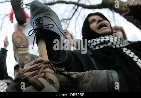 Dec 19, 2008 - London, England, United Kingdom - Stop the War Coalition holding shoes and protesting in front of the US embassy in London. This follows the arrest of al-Zaidi, the Iraqi journalist, who threw his shoes at US president GW Bush during his press conference in Baghdad earlier this week.  (Credit Image: © Tal Cohen/ZUMA Press) RESTRICTIONS: * UK Rights OUT * Stock Photo