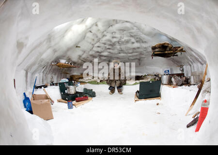 A young inuit sits on a bed in an igloo, surrounded by other necessary items to survive in the harsh cold climate. The inuit community near the north pole must adapt to global warming, as rising tempuratures may cause their homes of snow and ice to melt (Credit Image: © Ton Koene/ZUMApress.com) Stock Photo
