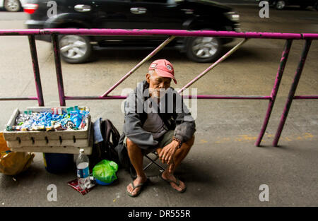 Pasay City, Philippines-January 20, 2014: Street vendor selling candies and cigarettes beneath the Santolan-Annapolis MRT station. Stock Photo