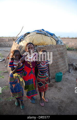 Ethiopian nomad family with their hut and animals Stock Photo