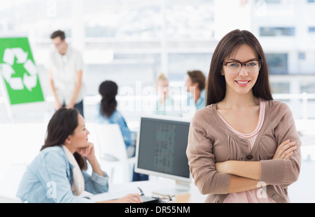 Female artist with colleagues in the background at office Stock Photo