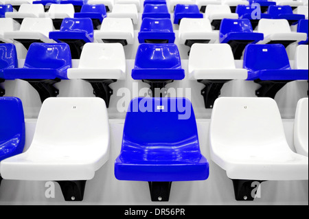 Empty blue and white seats inside sport arena stadium Stock Photo