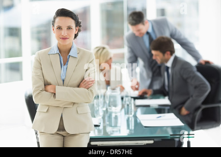 Businesswoman with colleagues discussing in office Stock Photo