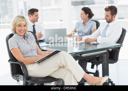 Young businesswoman with colleagues discussing in office Stock Photo