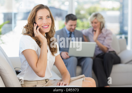Businesswoman on call with colleagues using laptop Stock Photo