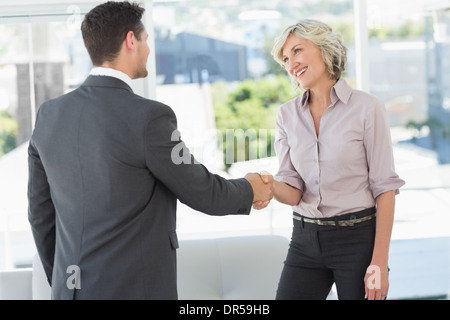 Side view of two executives shaking hands Stock Photo