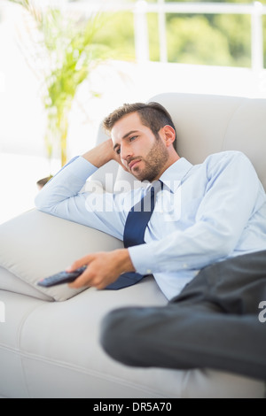 Relaxed well dressed man watching tv in living room Stock Photo