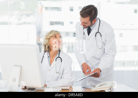 Doctors using digital tablet at medical office Stock Photo
