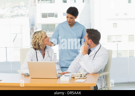 Three concentrated doctors in discussion Stock Photo