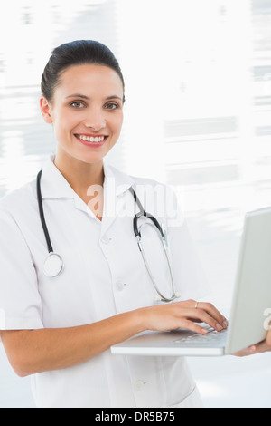 Portrait of a smiling female doctor using laptop Stock Photo