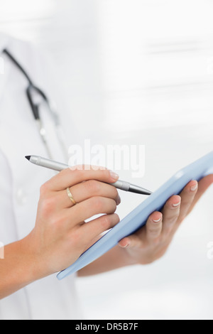 Mid section of a female doctor using digital tablet Stock Photo