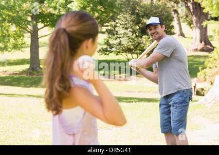 Father and daughter playing baseball Stock Photo