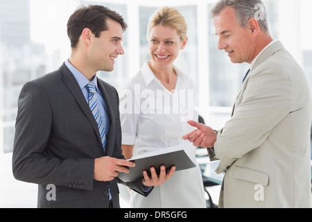 Smiling business team going over documents Stock Photo