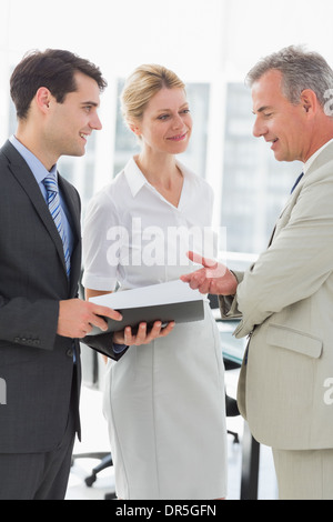 Smiling business colleagues talking together Stock Photo