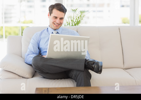Businessman using laptop sitting on the couch Stock Photo