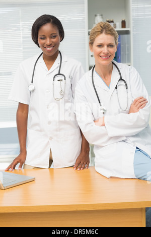 Doctor and nurse smiling at camera Stock Photo