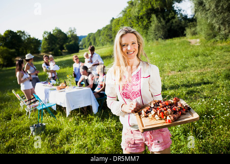 Friends barbecuing on the riverside, foothills of the Alps, Bavaria, Germany Stock Photo