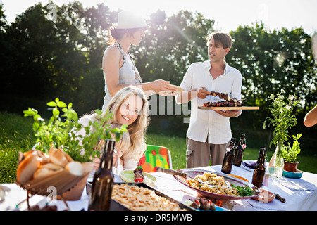 Friends barbecuing on the riverside, foothills of the Alps, Bavaria, Germany Stock Photo