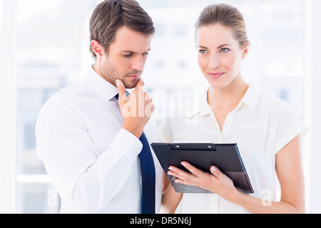 Smartly dressed colleagues using digital tablet Stock Photo