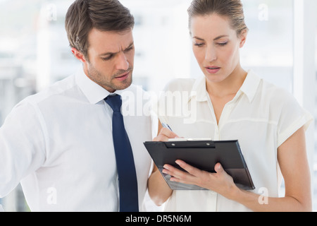 Smartly dressed colleagues using digital tablet Stock Photo