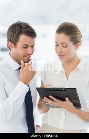 Smartly dressed colleagues using digital tablet Stock Photo