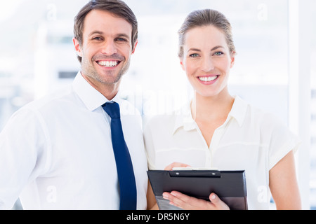 Smartly dressed colleagues using digital tablet Stock Photo