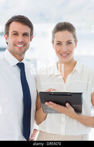 Smartly dressed colleagues using digital tablet Stock Photo
