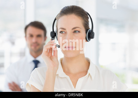 Close-up of a beautiful female executive with headset Stock Photo