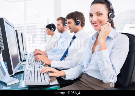 Business colleagues with headsets using computers Stock Photo