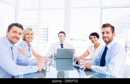 Executives sitting around conference table Stock Photo