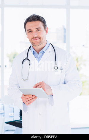Portrait of a male doctor using digital tablet Stock Photo