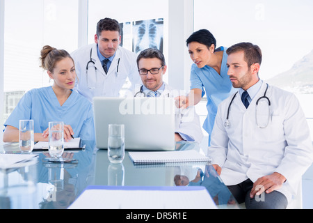 Concentrated medical team using laptop together Stock Photo