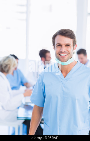Smiling male surgeon with colleagues in meeting Stock Photo