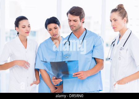 Group of doctors and surgeons examining x-ray Stock Photo