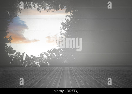 Splash on wall revealing bright sky Stock Photo