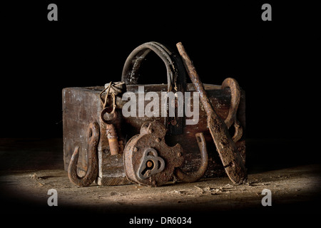 Old wooden nail box and rusty metal items. Stock Photo