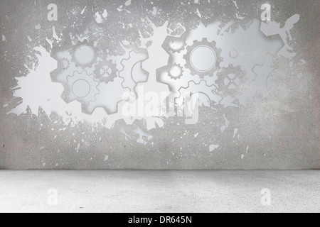 Splash on wall revealing cogs and wheels Stock Photo