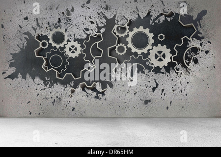 Splash on wall revealing cogs and wheels Stock Photo
