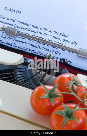 Tomatoes and typewriter Stock Photo