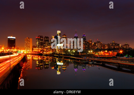A dusk image of the City of Philadelphia, is reflected in the still waters of The Scullykill River as seen from the South Bridge Stock Photo