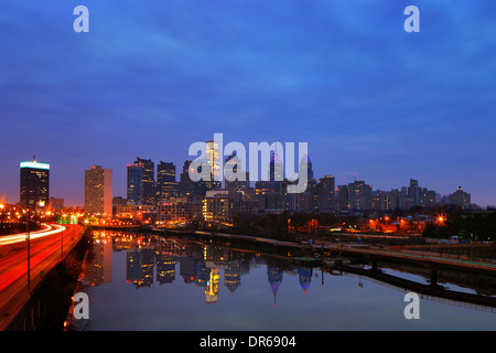 A dawn image of the City of Philadelphia, is reflected in the still waters of The Scullykill River as seen from the South Bridge Stock Photo