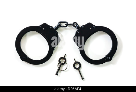 Steel handcuffs with the keys over the white background Stock Photo