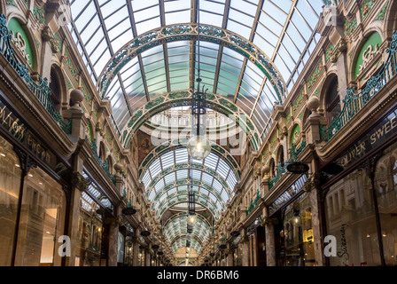 Ornate cast-iron segmental-arched roof trusses seen from the interior of County Arcade, Victoria Quarter, Leeds. Stock Photo