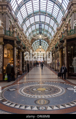 Ornate cast-iron segmental-arched roof trusses and mosaiced floor of County Arcade, Victoria Quarter, Leeds. Stock Photo