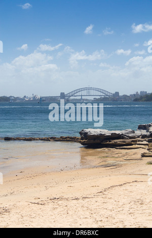 Milk Beach with Sydney Harbour Bridge and city skyline in background Sydney New South Wales NSW Australia Stock Photo