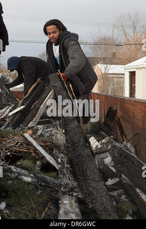 Detroit, Michigan USA - Volunteers from Wayne State University clear debris and board up vacant houses near Cody High School on the Martin Luther King Jr. holiday. Credit:  Jim West/Alamy Live News Stock Photo