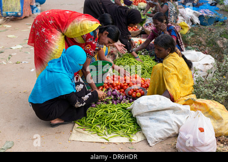 Indian women buying vegetables from a street market in Puttaparthi, Andhra Pradesh, India Stock Photo