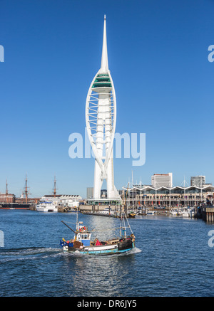 Fishing boat sailing in Portsmouth Harbour, the Solent, Hants, UK on a sunny day by the Spinnaker Tower and Gunwharf Quay Stock Photo